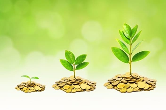 Three young plants growing from increasing piles of gold coins, symbolizing financial growth.