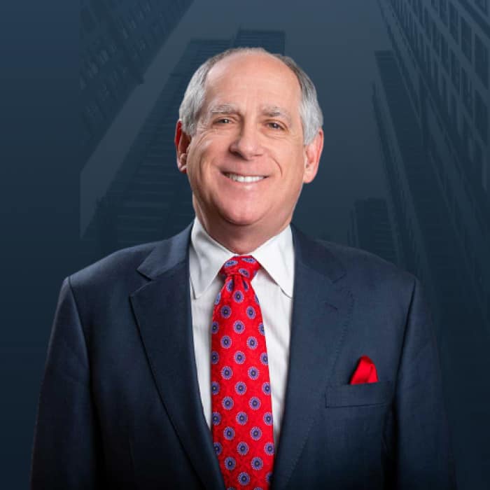 Headshot of Gary Altman in a dark suit and red tie.
