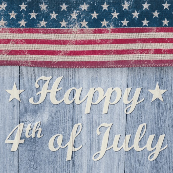 "Happy 4th of July" lettering on weathered blue wood beneath a vintage American flag.