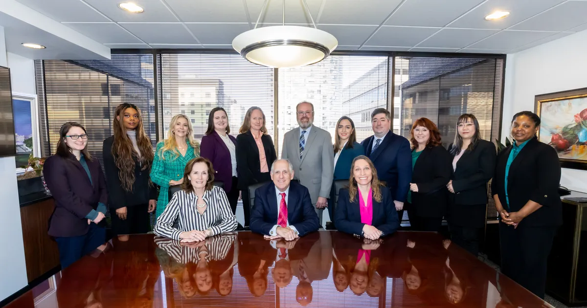 The full Altman & Associates team gathered around a conference table in their office.