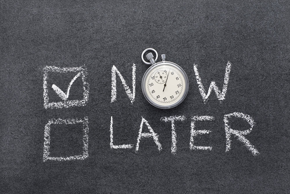 Chalkboard  with two check boxes with 'now' and 'later' written next to them. The 'now' box is checked off.