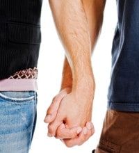 Two men holding hands romantically.