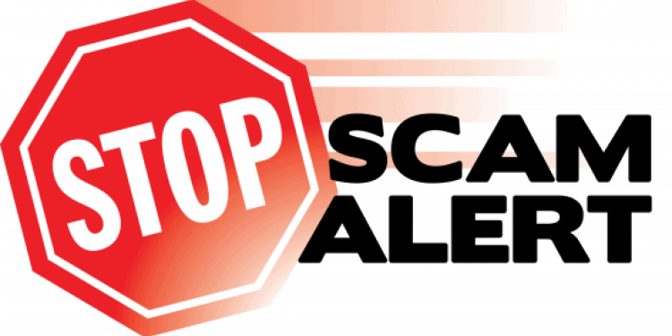 Stop sign with scam alert next to it.